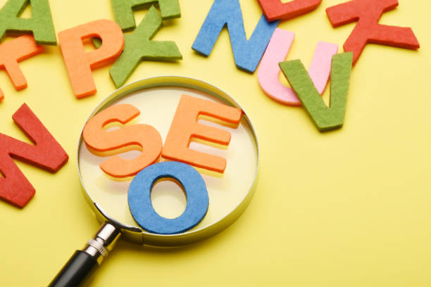 istock SEO concept. Search engine optimization SEO word with magnifying glass and colorful letters on the colored background with copy space 1458679908