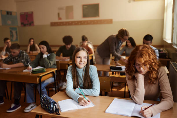 istock Large group of students having a class at high school. 1458680256