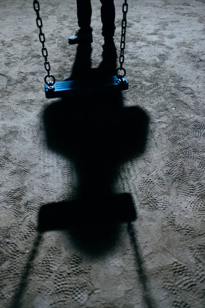 istock A swing and a suspicious figure at night 1458681118