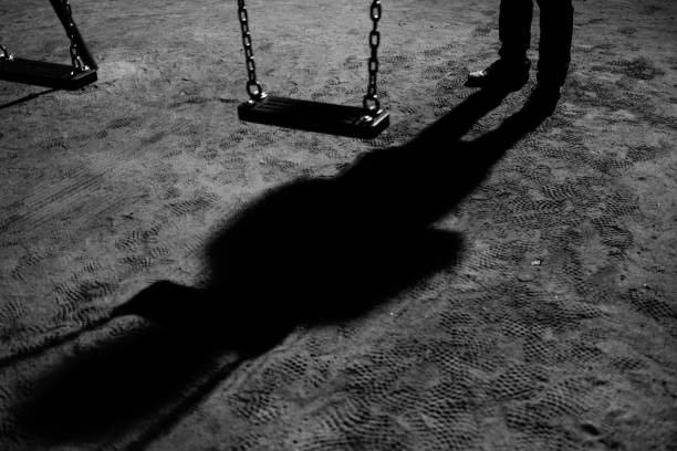 istock A swing and a suspicious figure at night 1458681120