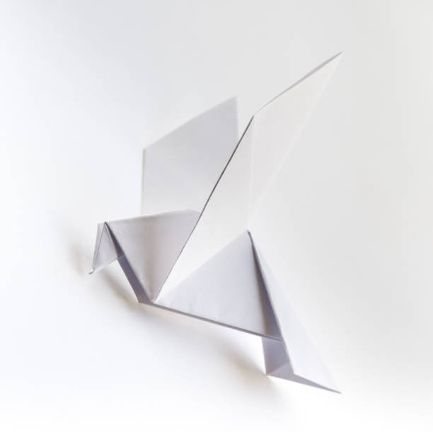 istock Paper dove origami isolated on a white background 1458681432