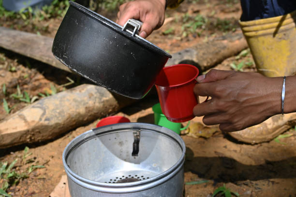 istock Man Putting Coffee in Cup-Stock Photo 1458682674