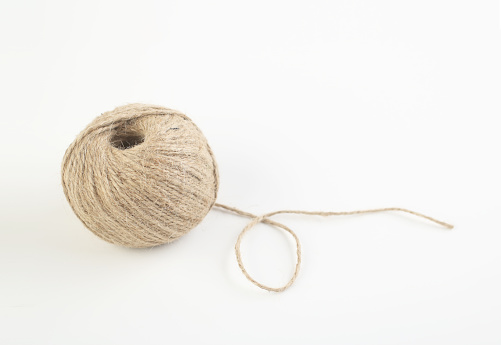Ball of Jute twine on white background .