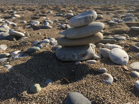 Stack of round smooth stones on a seashore