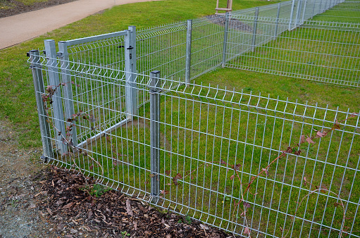 a low wire fence separates the individual small grassy areas of the gardens close together in a row. rows of apartments with terraces and small gardens for dog runs, kennels. back yard, bussines, condominium