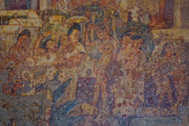 Detailed close up of  murals paintings frescos inside Ajanta Cave number 2 dating to 2nd Century AD. This mural shows a music and dance function with men and women. stock photo