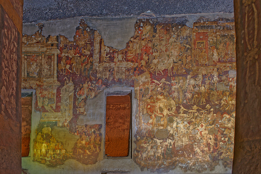 detail of the fresco in Pompeii with winged griffin on a red background Pompeian