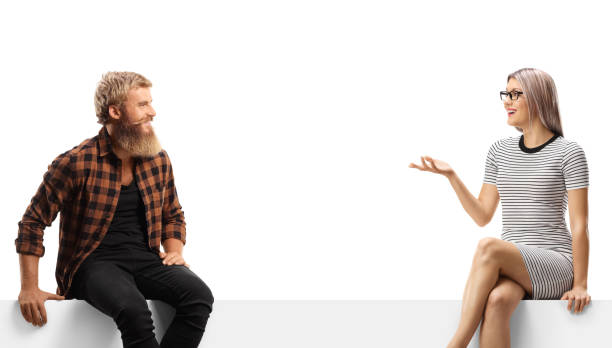 istock Guy sitting on a white panel and listening to a young woman talking 1458690161