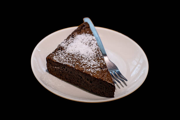 istock Isolated brownie on white dish on black background. 1458691041
