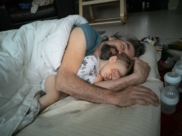istock Dad and kid sleeping together and hugging. 1458691266