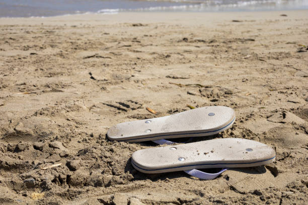Slippers upside down in the sand because of the hot sun.