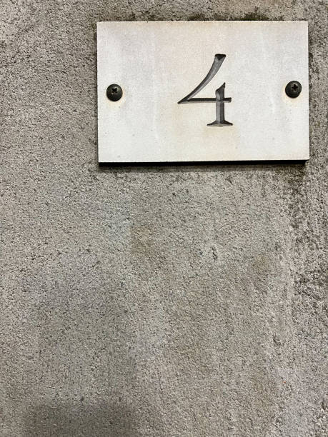 istock number 4 on white plate on gray concrete wall 1458692761