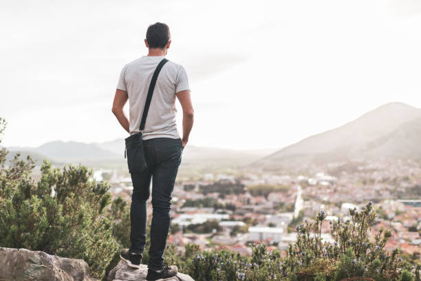 istock Young man breathing fresh air in mountains at sunset 1458693001