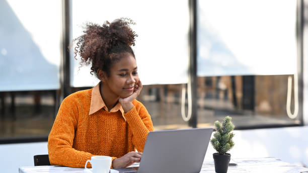 istock Pleasant African American female investor checking financial data on her laptop computer. 1458693003