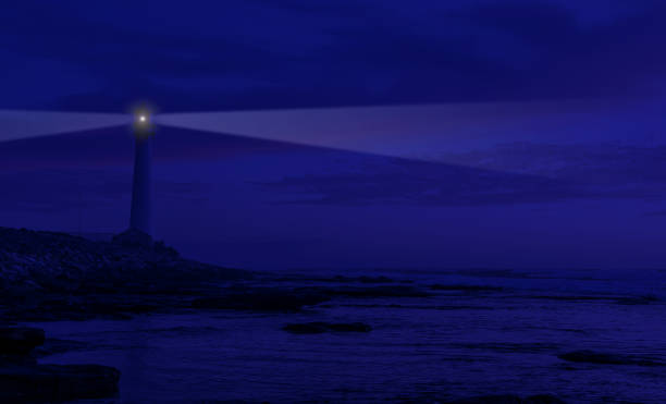 istock View of Coastal lighthouse at night with warning lights blazing 1458693650