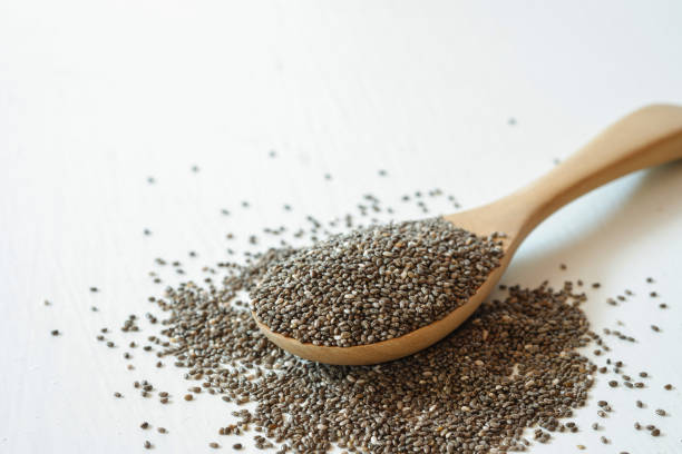 istock Chia seeds in a wooden spoon on a white background. 1458695593