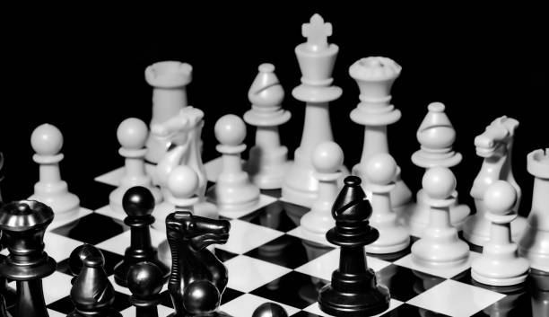 istock Close up of Chess pieces on a reflective mirror board surface wi 1458695700