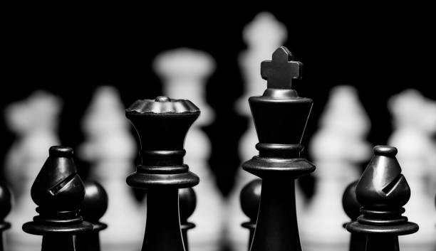 istock Close up of Chess pieces on a reflective mirror board surface wi 1458696925