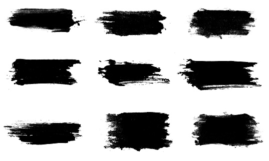 set of nine black strokes of paint isolated on a white background.