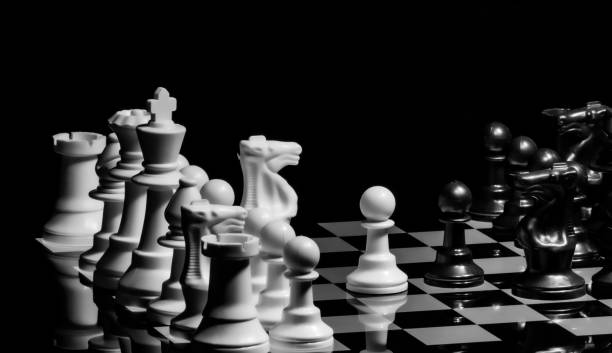 istock Close up of Chess pieces on a reflective mirror board surface wi 1458698226
