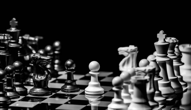 istock Close up of Chess pieces on a reflective mirror board surface wi 1458698239