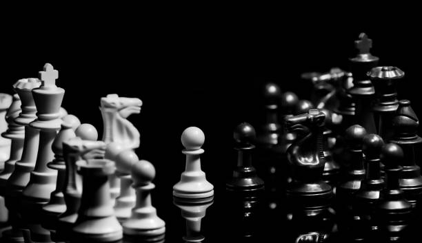 istock Close up of Chess pieces on a reflective mirror board surface wi 1458698293