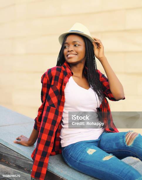 Portrait Of Beautiful Smiling Young African Woman Posing Wearing Summer Straw Hat In The City Stock Photo - Download Image Now