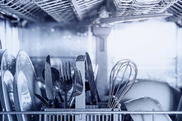 istock Open dishwasher with clean utensil inside, cutlery, glasses, dishes at kitchen 1458699215