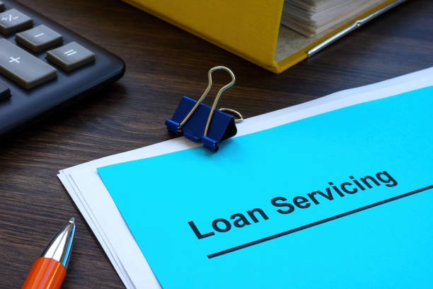 istock Loan servicing papers near folder and calculator. 1458700617