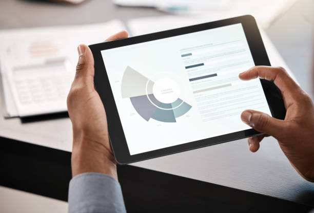 istock Hands, tablet and data with a business man doing finance research on a wireless display in his office at work. Accounting, financial and tech with a male analyst working with information technology 1458700962