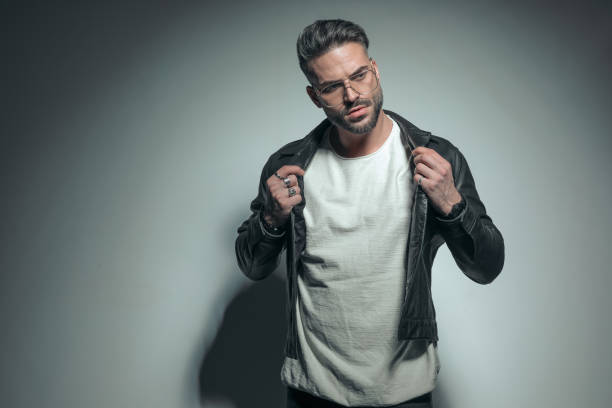 istock handsome casual man arranging his leather jacket 1458701222