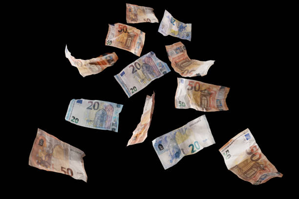 Flying money, twenty and fifty paper banknotes in euro currency coming down, isolated on a back background, finance concept, business success, investment or lottery win, copy space stock photo