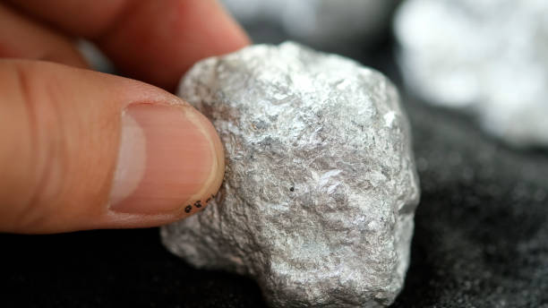 miners hold in their hands platinum or silver or rare earth minerals found in the mine for inspection and consideration - scandium imagens e fotografias de stock