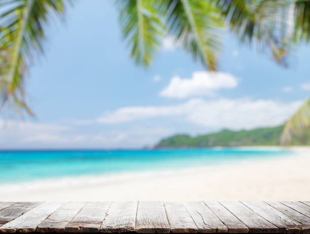 istock Empty wooden table or pier with sunny beach and sea 1458704312