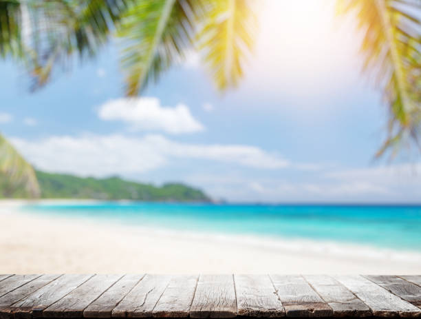 istock Empty wooden table or pier with sunny beach and sea 1458704391