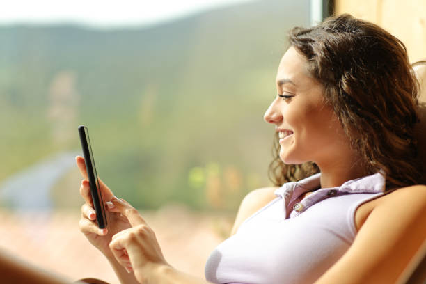 istock Woman using cell phone on a chair at home 1458704548
