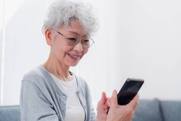 istock Senior woman using her smartphone with a smile 1458706541