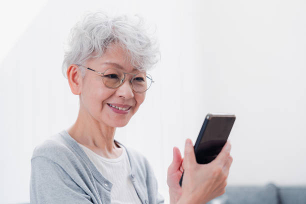 istock Senior woman using her smartphone with a smile 1458706549