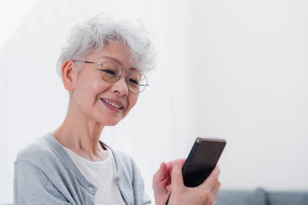 istock Senior woman using her smartphone with a smile 1458706556