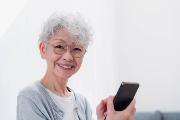 istock Senior woman using her smartphone with a smile 1458706563