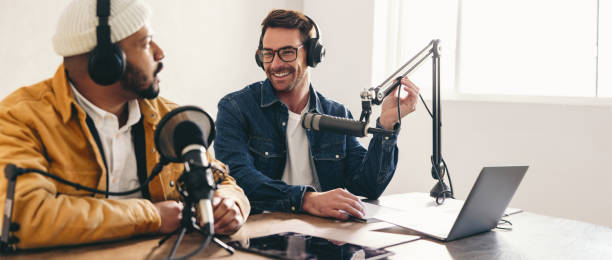 istock Happy radio presenter interviewing a guest on a podcast 1458706793
