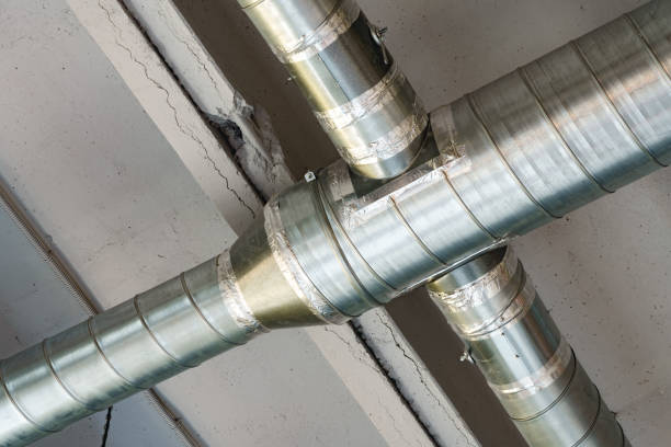 istock Silver ventilation pipes hanging from the ceiling inside the building 1458706806