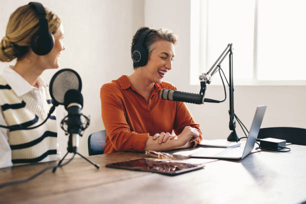 istock Happy female podcasters co-hosting a show in a home studio 1458706871