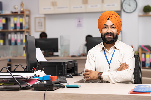 Indian Sikh businessman working at office