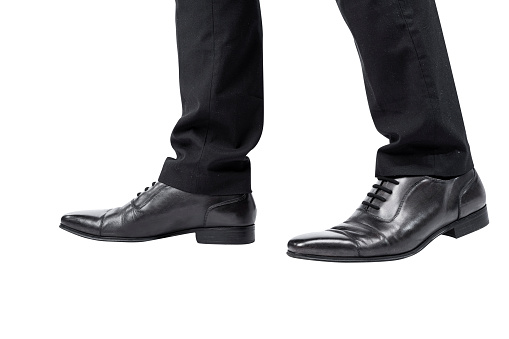 Closeup view of the businessman's foot isolated over white background