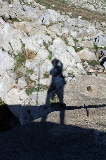 istock shadow of man on rocks 1458710566