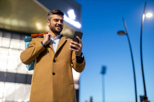 istock Young man using smart phone after shopping 1458710586