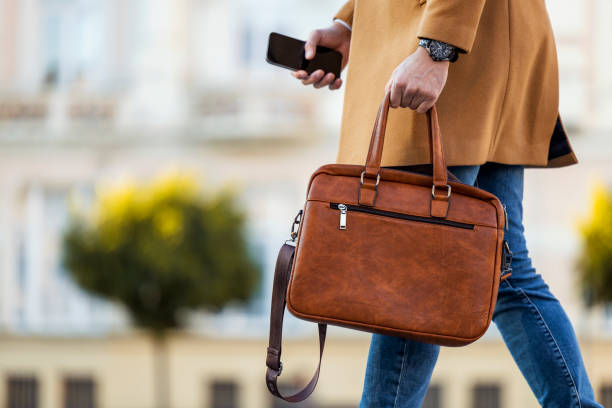 istock Businessman holding a briefcase outdoor 1458710806