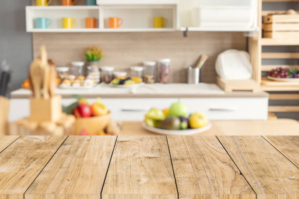istock Wood table top with blur kitchen counter decoration for montage product display. background for cooking food layout concept. 1458711138