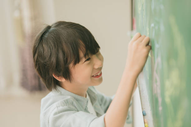 asian boy happy smile enjoy education at school in classroom writing answer at chalkboards - preschooler plant preschool classroom imagens e fotografias de stock